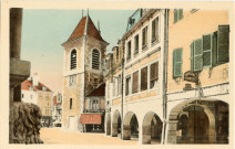 Lons-le-Saunier (Jura). La rue du commerce et la tour de l'horloge. Chalon-sur-Saône, imprimerie Bourgeois Frères.