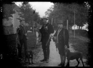 Trois chasseurs avec leurs chiens et du gibier