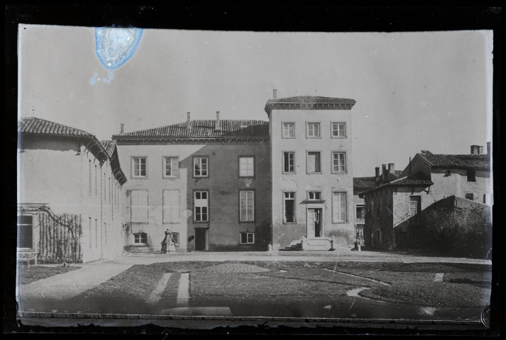 Maisons et fontaine autour d'une place.